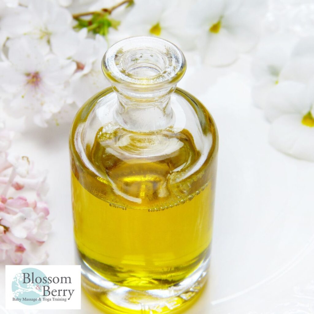 What Is the Best Oil for Newborn Skin? - picture of a bottle of oil on a table covered in flower petals