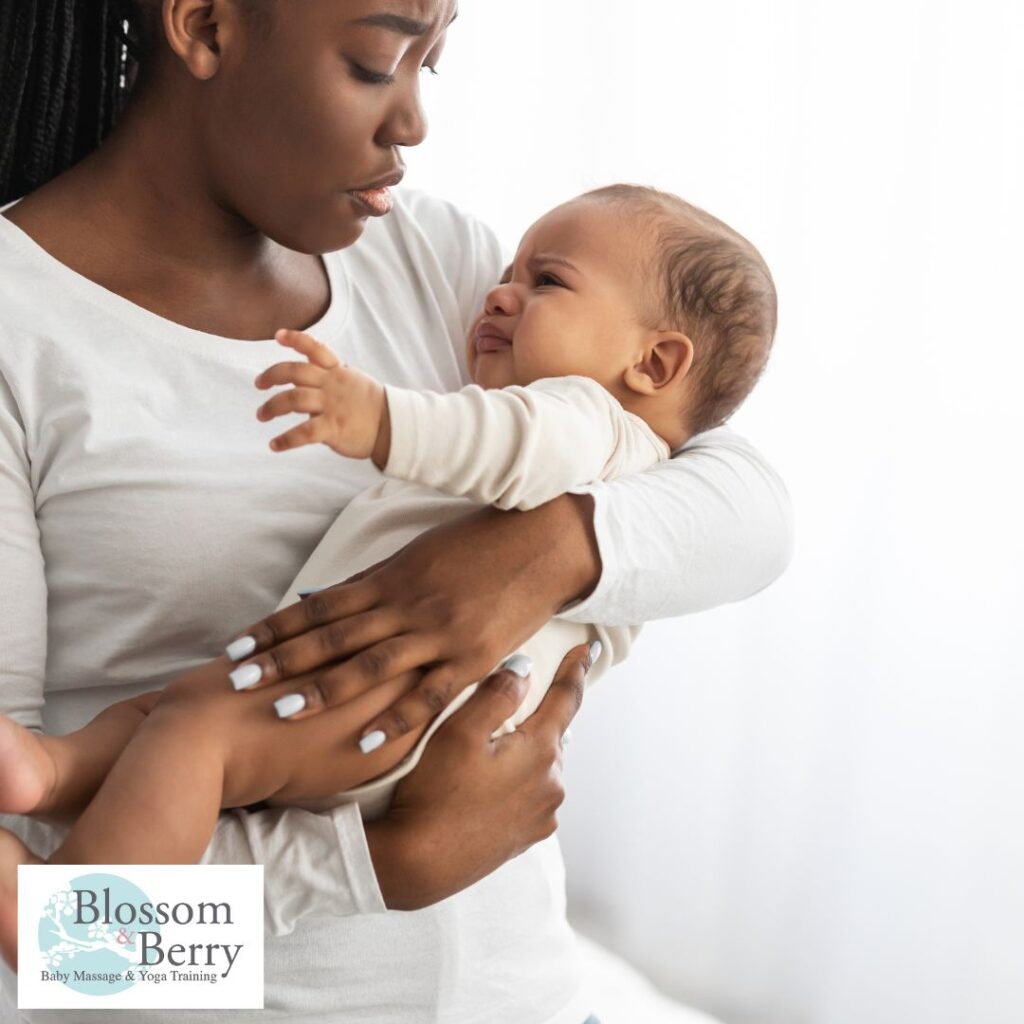 Can Baby Yoga Help with Colic? - picture of a mum holding her baby