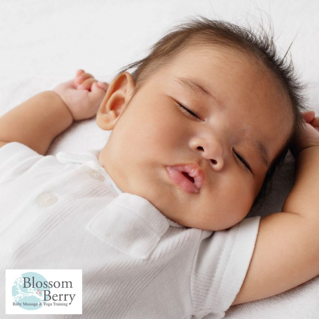 Does Baby Yoga Help with Sleep? Benefits for Babies and Parents - picture of a baby asleep on it's back with it's arms in the air